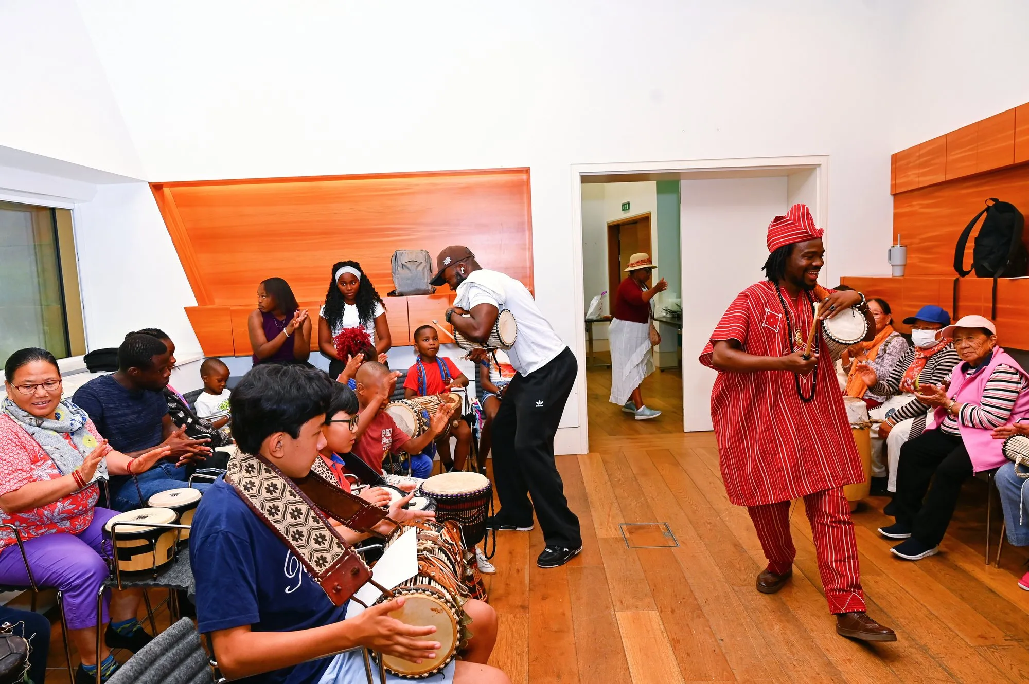 The workshop room fills with drums